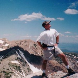 Ed Lloyd posing on mountaintop