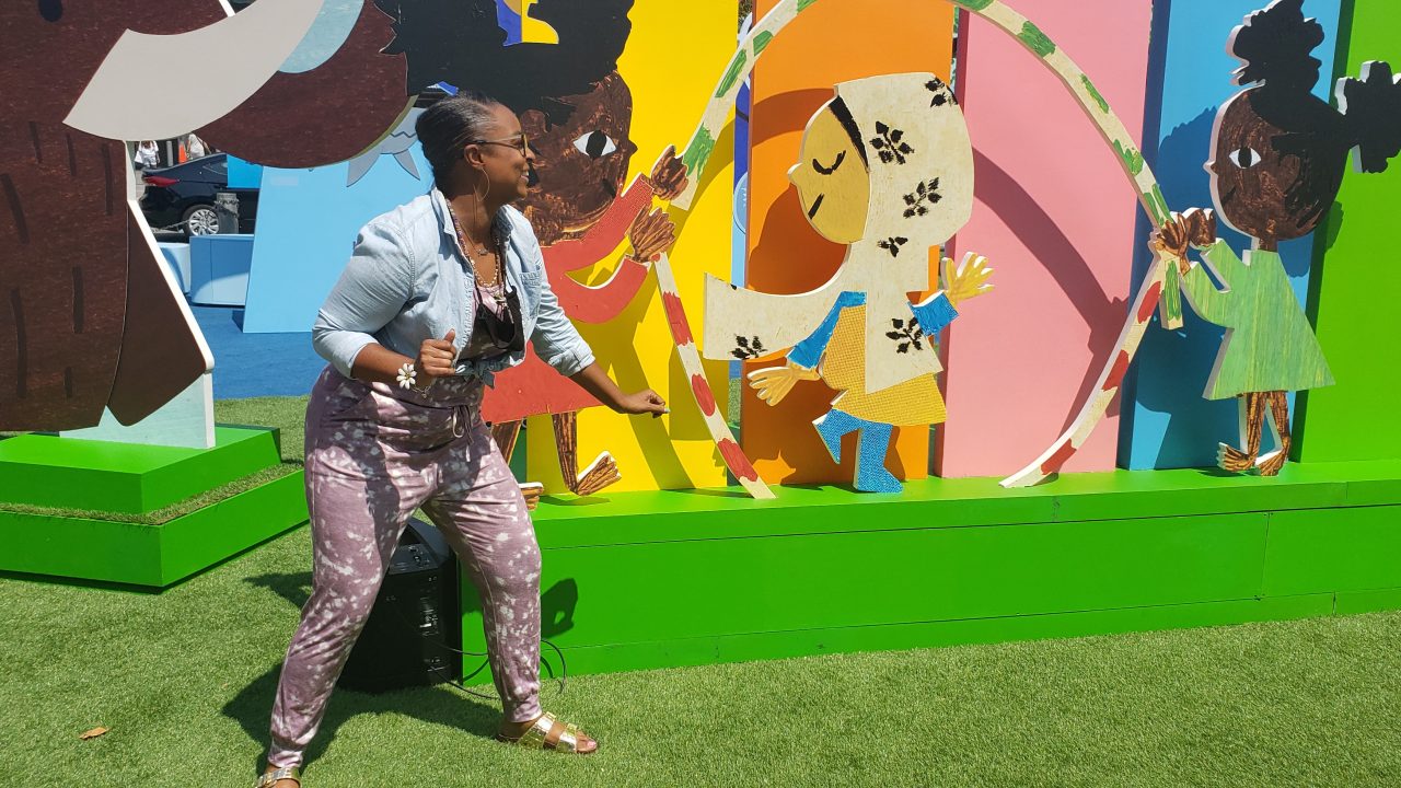 Janelle pretending to double dutch at the Christian Robinson exhibit at Jack London Square in Oakland, CA.
