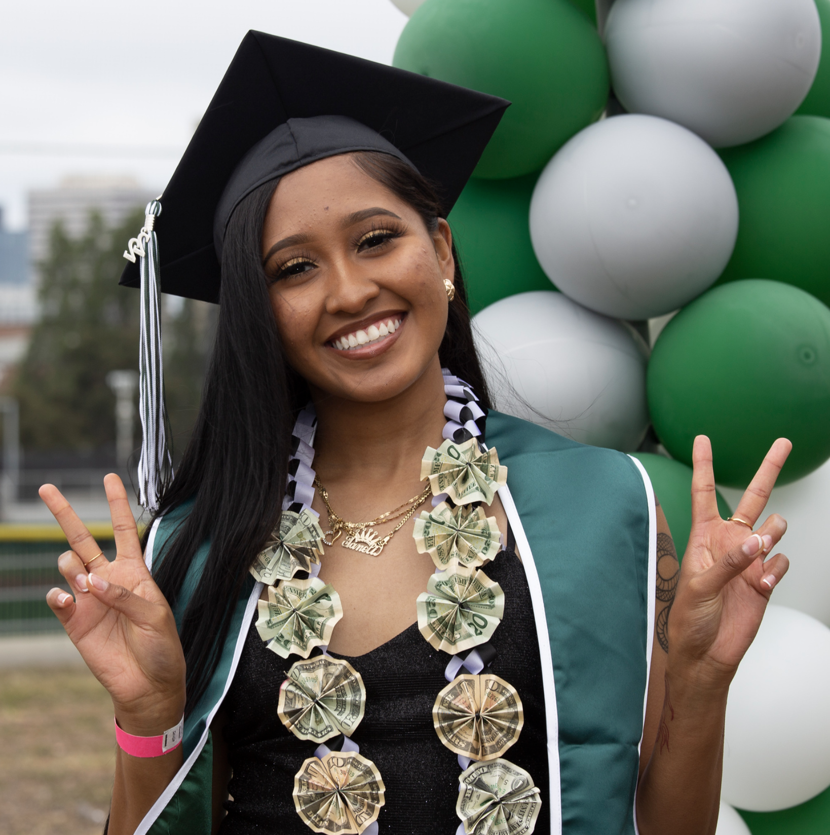 Laney College Graduate with balloons